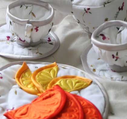 Soft sculptures cups and saucers, made from embroidered fabric, this tea-service comes complete with orange and lemon slices,
